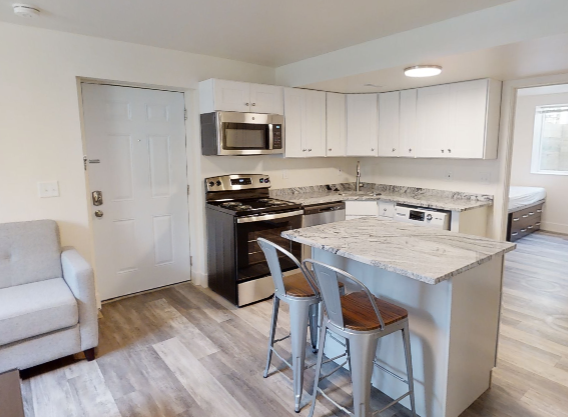 a kitchen with an island and two bar stools